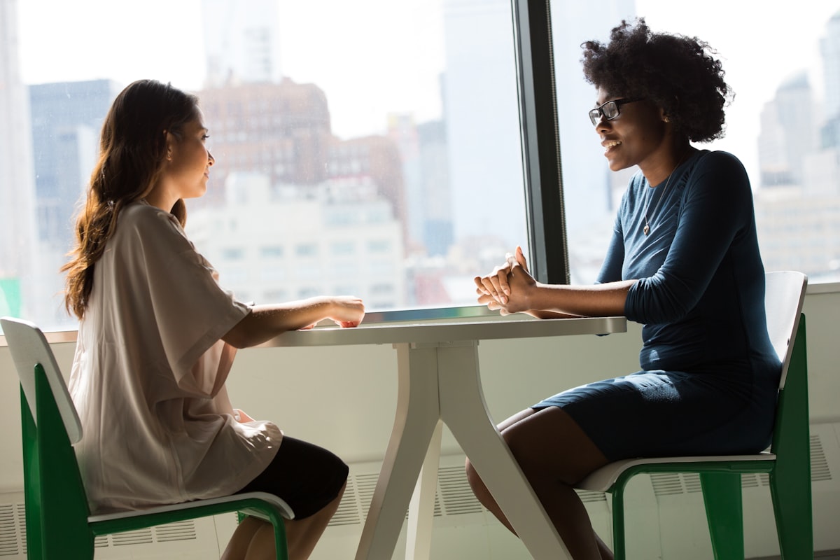 A parent and an educator talking together at a table